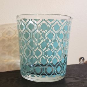 New Glass jar with teal geometric pattern.